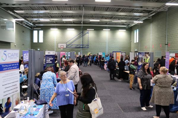 People at job fair in sports hall