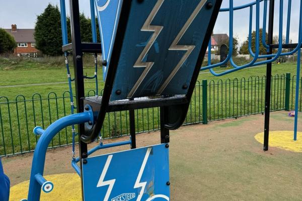 Image depicts play equipment damaged by arson in Goscote