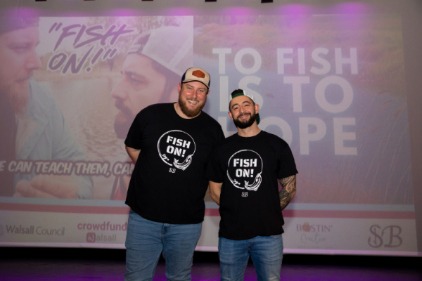 Image depicts two people from Snagged Bro at the film premiere of Fish On