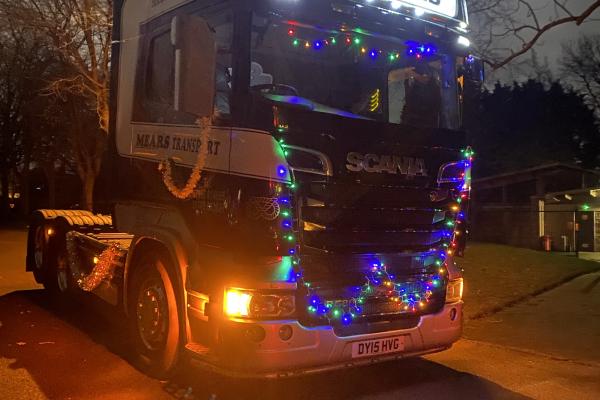 Image depicts a truck with Christmas lights. 