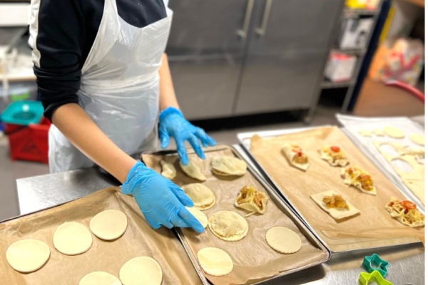 Image depicts someone preparing savoury pastries.