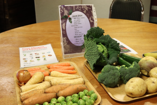 Image depicts a presentation of vegetables on a tray with the menu and food allergen notice on display.