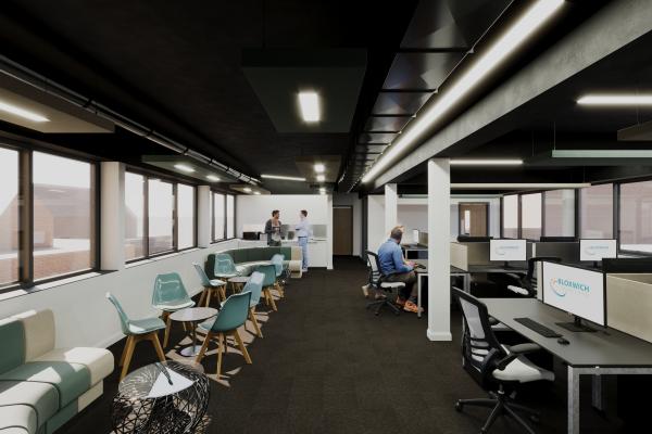 A bright modern office space with teal and grey seating and a bank of computers