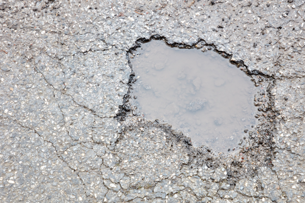 Pothole in road filled with water