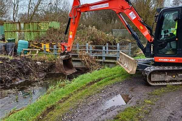 Digger completing dredging work at Grenfell Road Allotments in Little Bloxwich