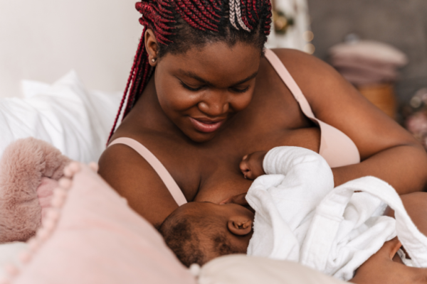 Image depicts a woman breastfeeding her baby.