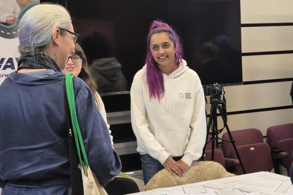 Three people having a conversation at a skills expo event