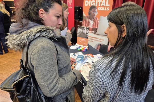 two ladies speaking at a skills expo event