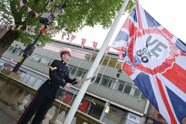 VE day flag being raised outside Walsall Council House