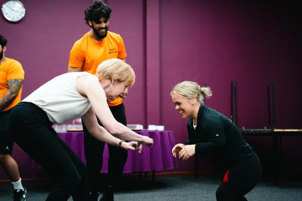 Image depicts Wendy Morton MP and Ellie Simmonds MBE taking part in a group exercise.