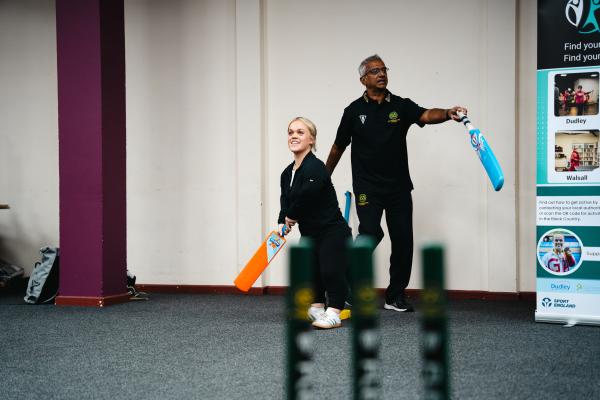 Image depicts Ellie Simmonds MBE taking part in indoor cricket.