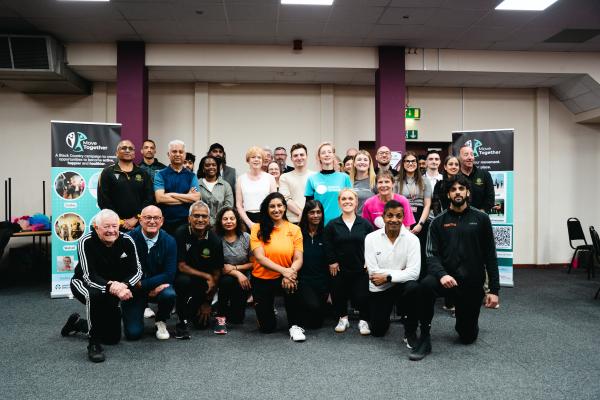 Image depicts a large group of people who attended the Move Together campaign launch at Manor Farm Community Association.