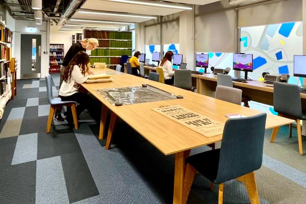 Research room of Walsall Archives, showing people sitting at a table and computers