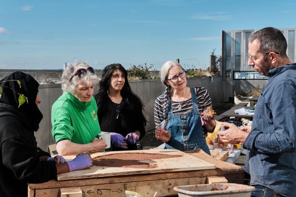 Women from Caldmore Community Garden taking part in a workshop at The New Art Gallery Walsall's terrace