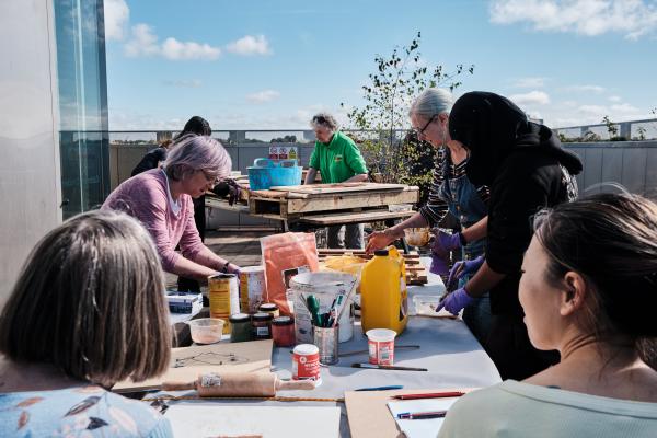 Women from Caldmore Community Garden taking part in a workshop at The New Art Gallery Walsall's terrace