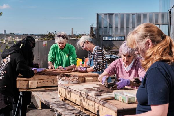 Women from Caldmore Community Garden taking part in a workshop at The New Art Gallery Walsall's terrace