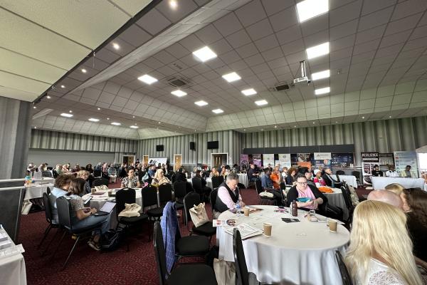 Image depicts a large room of conference attendees at Walsall Football Club.