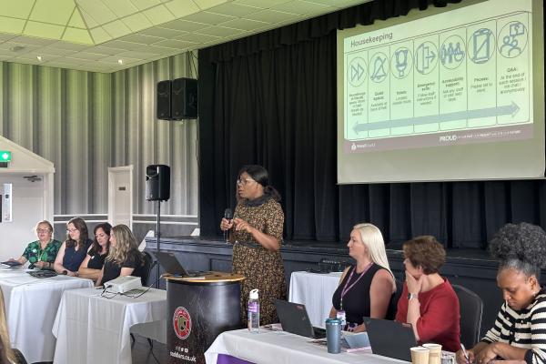 Image depicts Angela Aitken speaking at the Neurodiversity Conference.