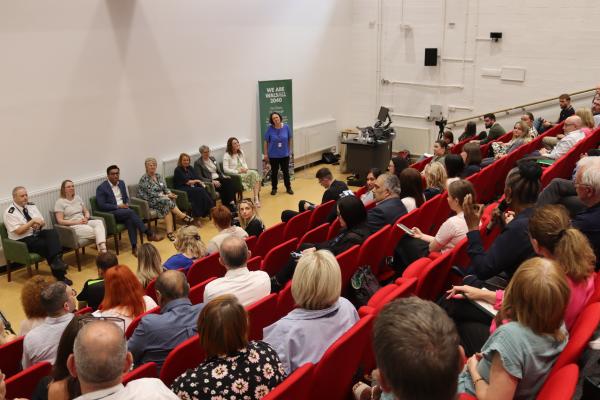 Image depicts a panel discussion at the We are Walsall 2040 conference, with an attendee asking a question.