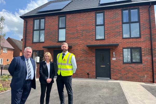 Cllr Andrew, whg and contractor standing outside new build house on margam crescent