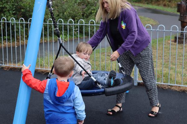 Children using play area equipment
