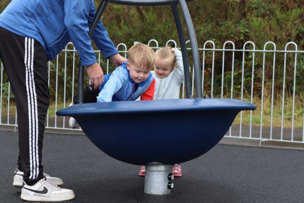 Children using play area equipment
