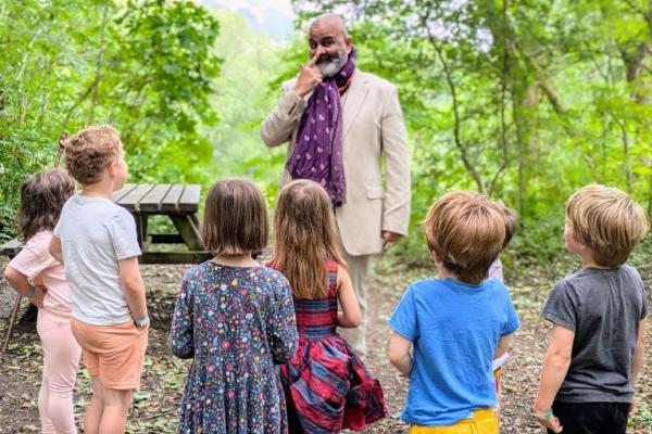 Storyteller Peter Chand in front of a small audience of children