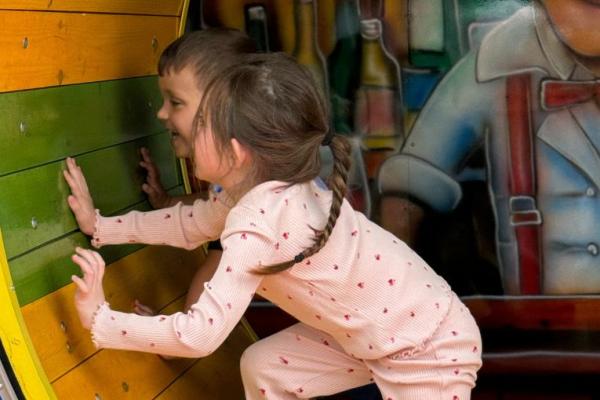 Two children enjoying an amusement ride
