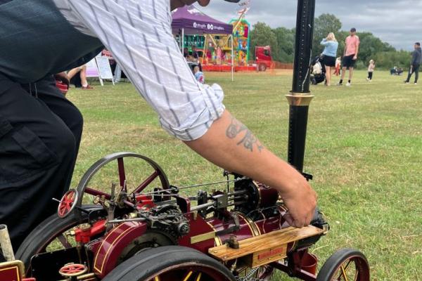 A man working on a tiny traction engine