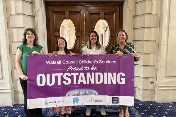 DMT with banner outside council chamber