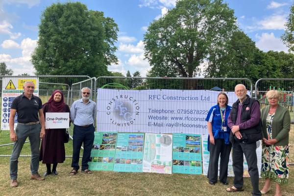 Group members outside fencing with signage 