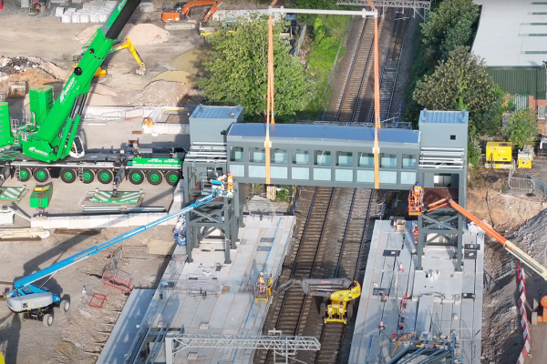 a station footbridge being craned onto site