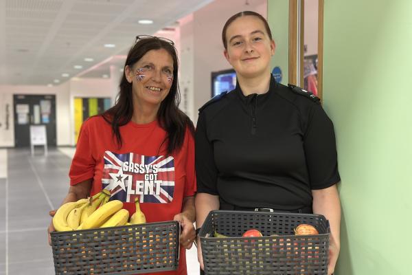 Sassy Sensory Surprises team members holding baskets of fruit at the HAF programme