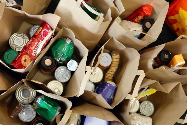 Image depicts food parcel bags containing food and essentials.