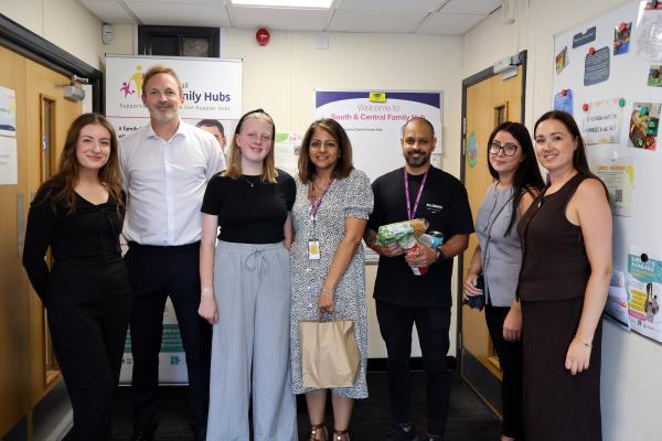 Image depicts employees from Opus and Walsall Council, with one of them holding a food parcel bag.